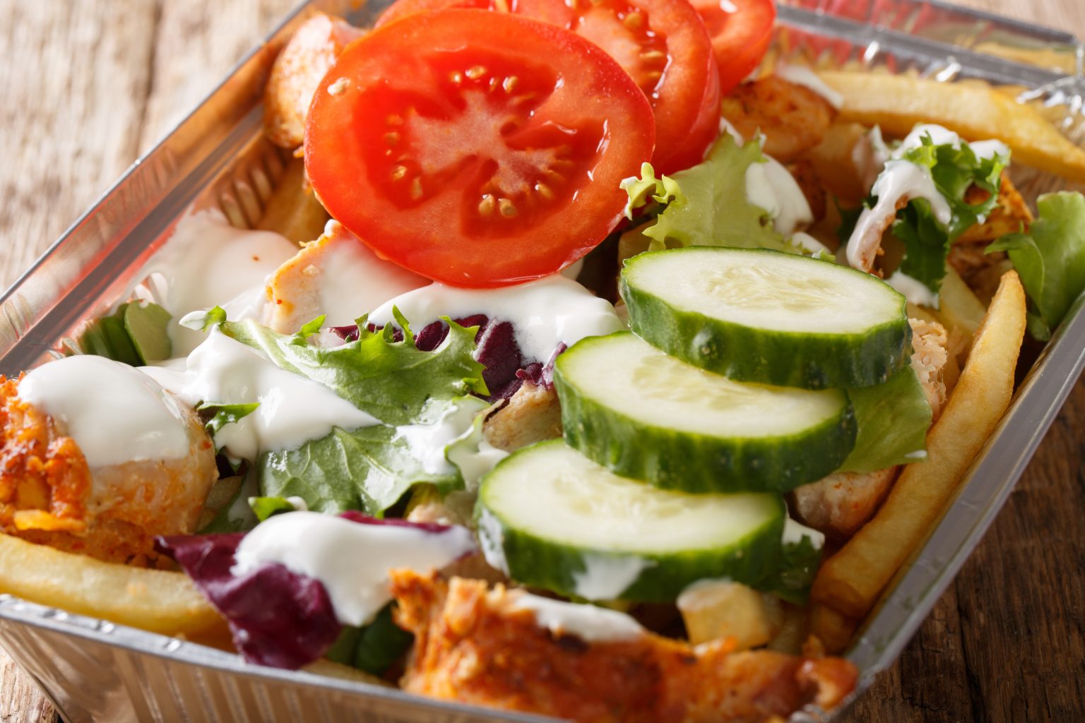 Traditional Dutch fast food kapsalon of french fries, chicken, f